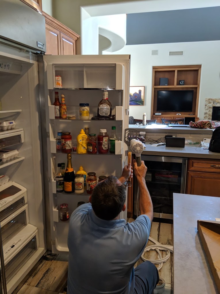 Technician repairing a refrigerator in Knoxville