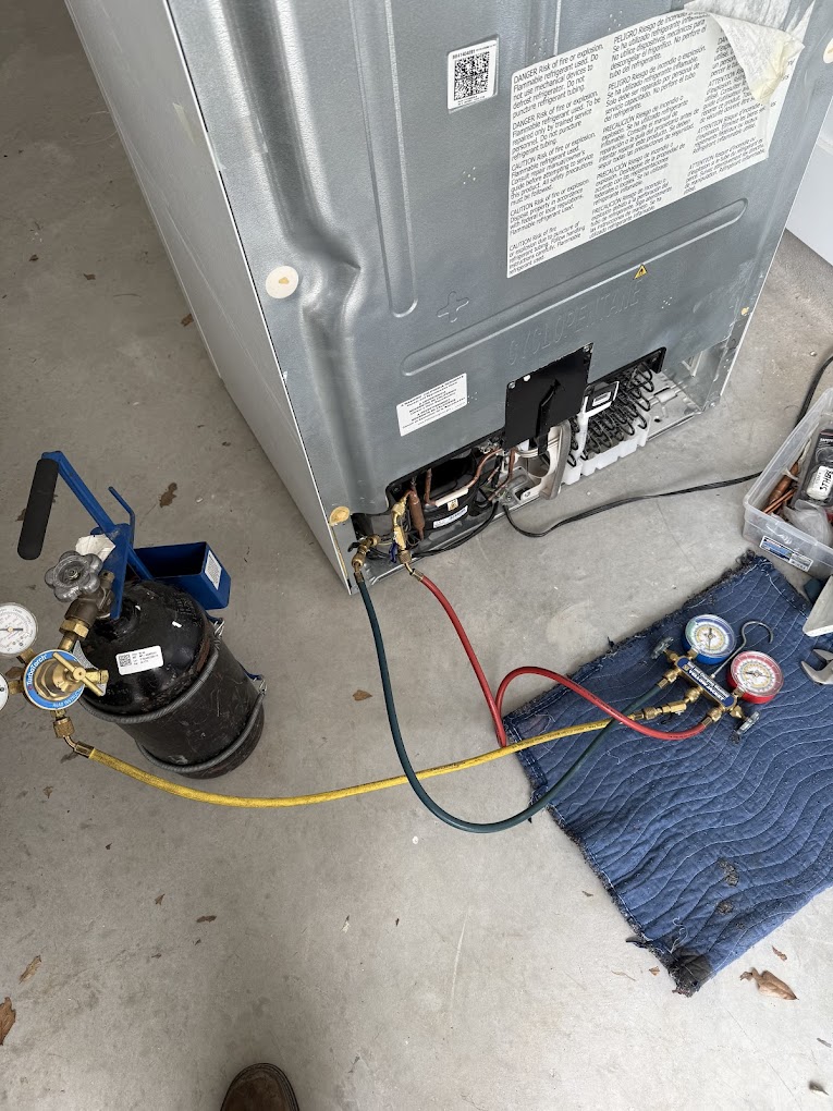 Refrigerator sealed system service in progress